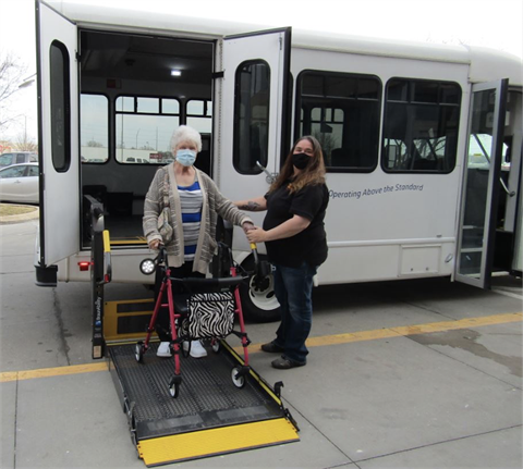 Wendy Schick, OATS Transit driver, assists passenger Nancy Bell who starting May 5 can use the service four times a month to nearly any destination in the city and, one day a month, to locations in Raymore, Grandview and Harrisonville.